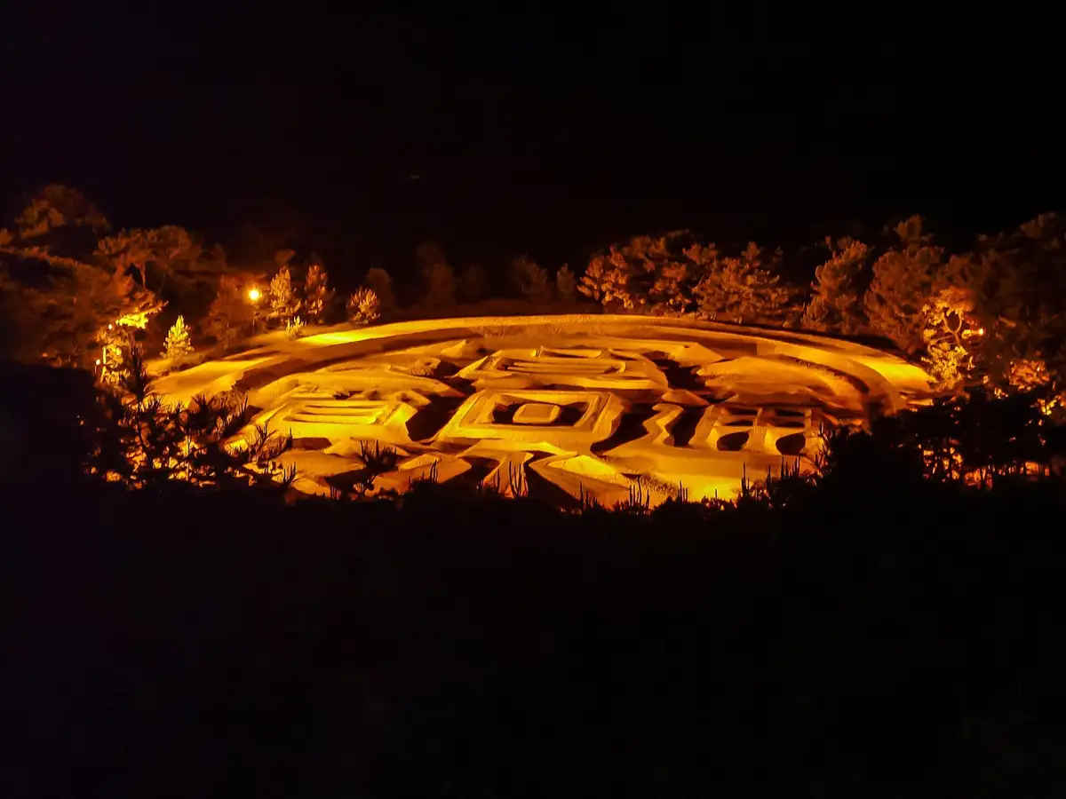 Zenigata Sunae coin sand drawing lit at night, Kanonji